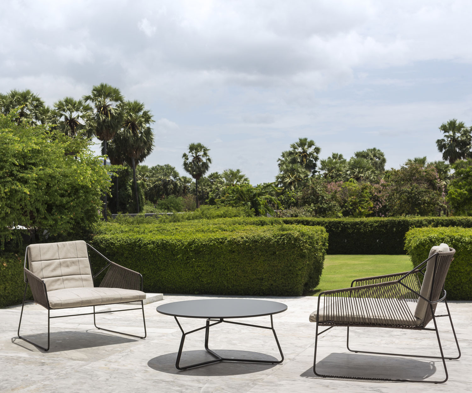 Fauteuil design exclusif Oasiq Ficelle sur la terrasse du jardin en été